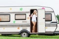 Young and beautiful hippy girl standing in trailerÃ¢â¬â¢s door. Royalty Free Stock Photo